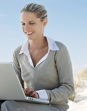Image of a woman in front of her laptop