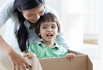 A mom unpacking boxes with her son