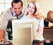 Image of a couple of employees looking at a computer